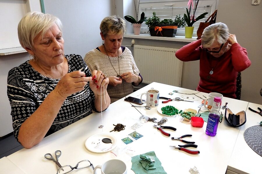 Zdjęcie przedstawia osoby biorące udział w warsztatach biżuteryjnych